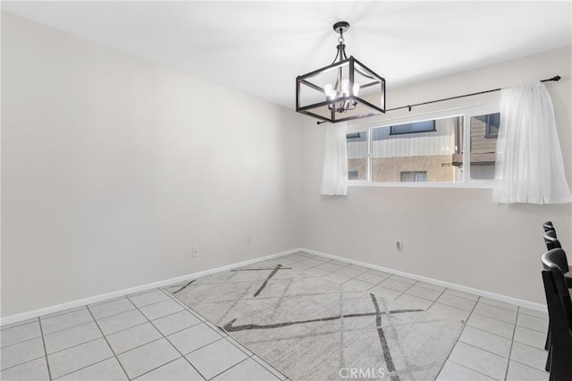 unfurnished dining area featuring light tile patterned floors and a notable chandelier