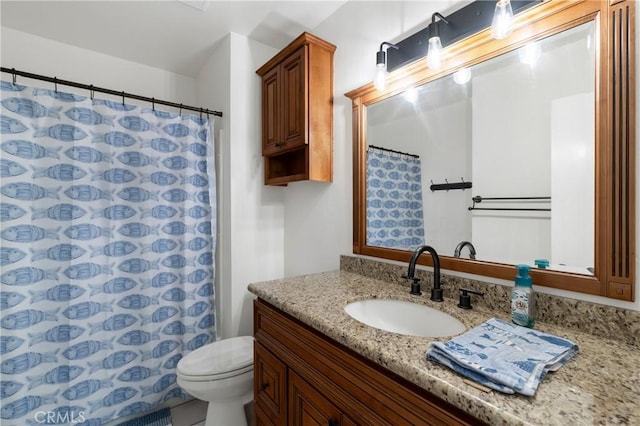 bathroom with toilet, vanity, and a shower with shower curtain