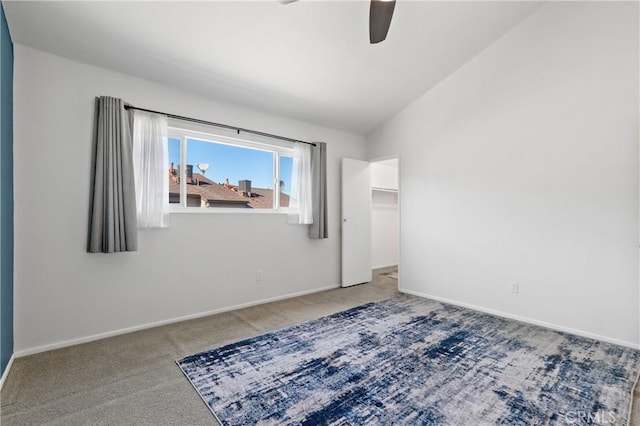 unfurnished room with ceiling fan, lofted ceiling, and carpet floors