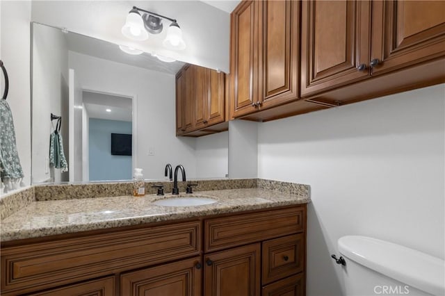 bathroom featuring toilet and vanity