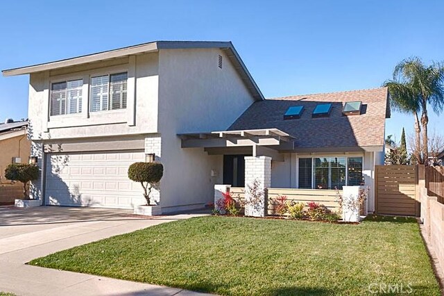 view of front of house with a garage and a front lawn