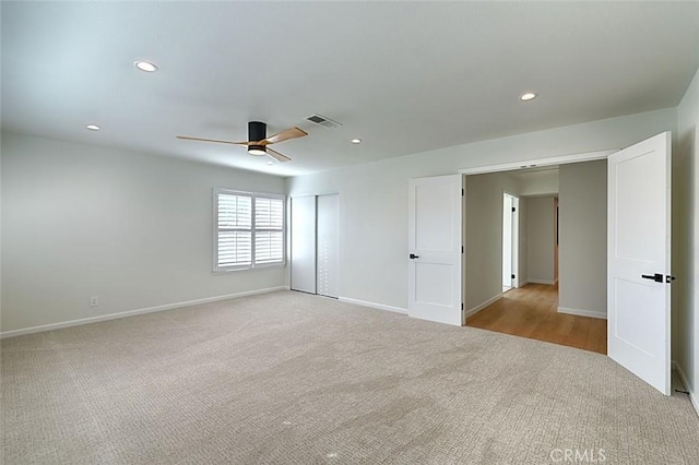 carpeted spare room featuring ceiling fan