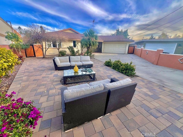 view of patio / terrace with an outdoor living space and a garage