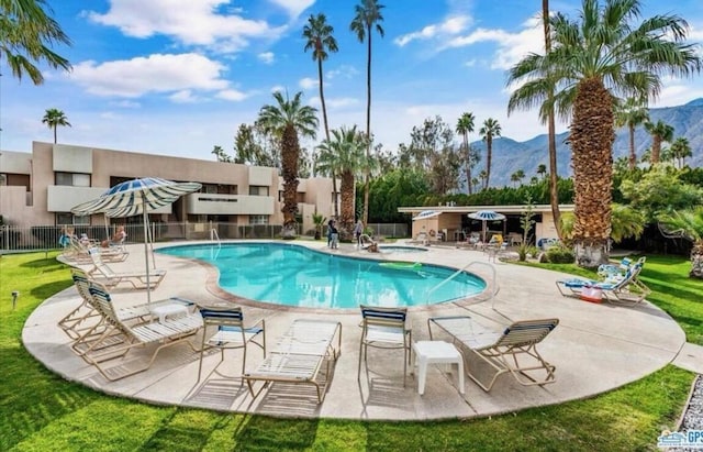 view of pool with a patio area and a mountain view