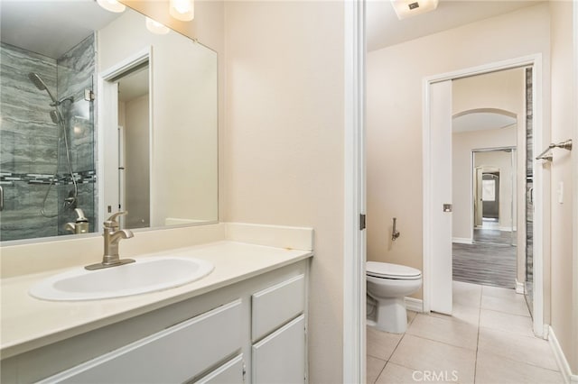 bathroom with vanity, tile patterned floors, toilet, and walk in shower