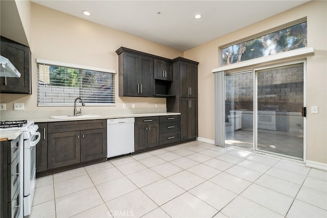 kitchen featuring white appliances, plenty of natural light, sink, and dark brown cabinets