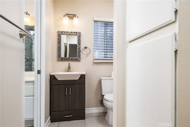 bathroom featuring vanity, toilet, and tile patterned flooring