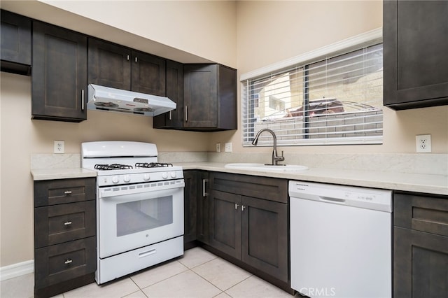 kitchen featuring white appliances, sink, and dark brown cabinets