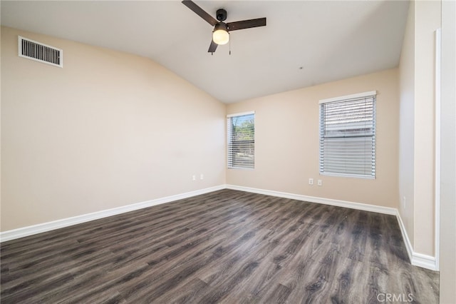 spare room with vaulted ceiling, dark wood-type flooring, and ceiling fan