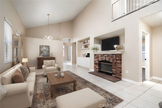 tiled living room featuring high vaulted ceiling, an inviting chandelier, built in features, and a fireplace