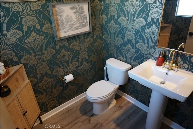 bathroom featuring wood-type flooring and toilet