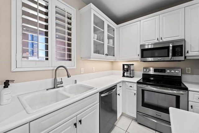 kitchen with sink, white cabinetry, and appliances with stainless steel finishes