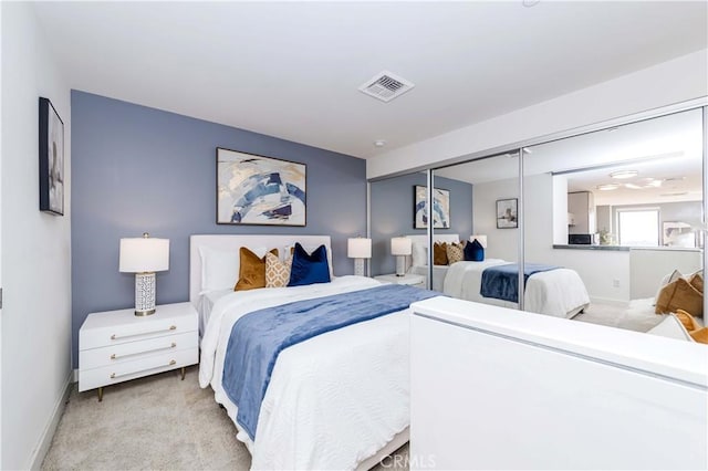 bedroom featuring a closet and light carpet