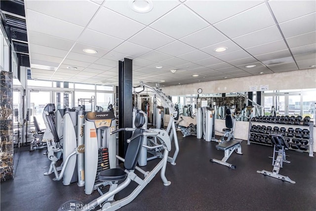 workout area with a paneled ceiling and a wealth of natural light