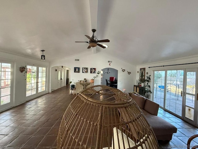 tiled living room featuring french doors, ceiling fan, and vaulted ceiling