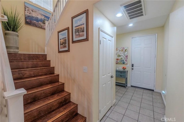 stairs featuring tile patterned flooring