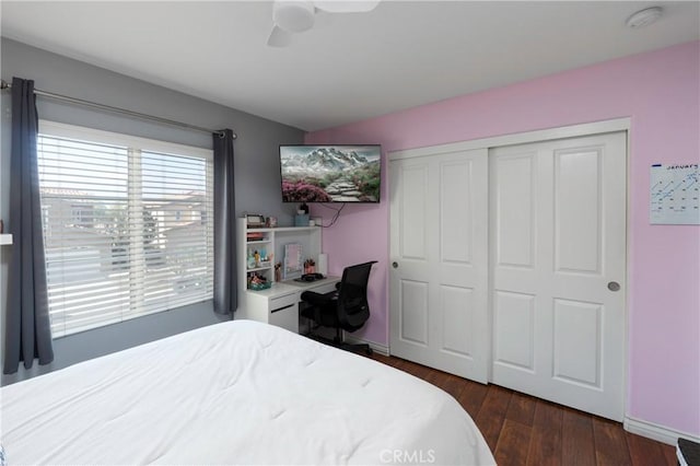 bedroom with ceiling fan, dark hardwood / wood-style flooring, and a closet