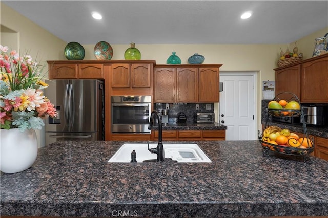 kitchen with decorative backsplash, sink, and stainless steel appliances