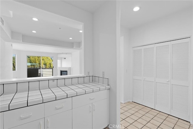 unfurnished bedroom featuring a closet and light tile patterned flooring