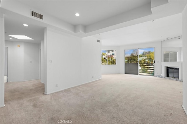 unfurnished living room featuring light colored carpet