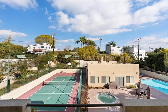 exterior space with a fenced in pool and tennis court