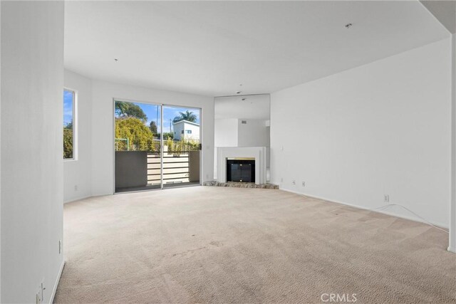 unfurnished living room featuring light colored carpet