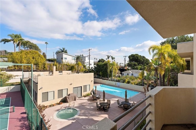 view of pool with a community hot tub and a patio