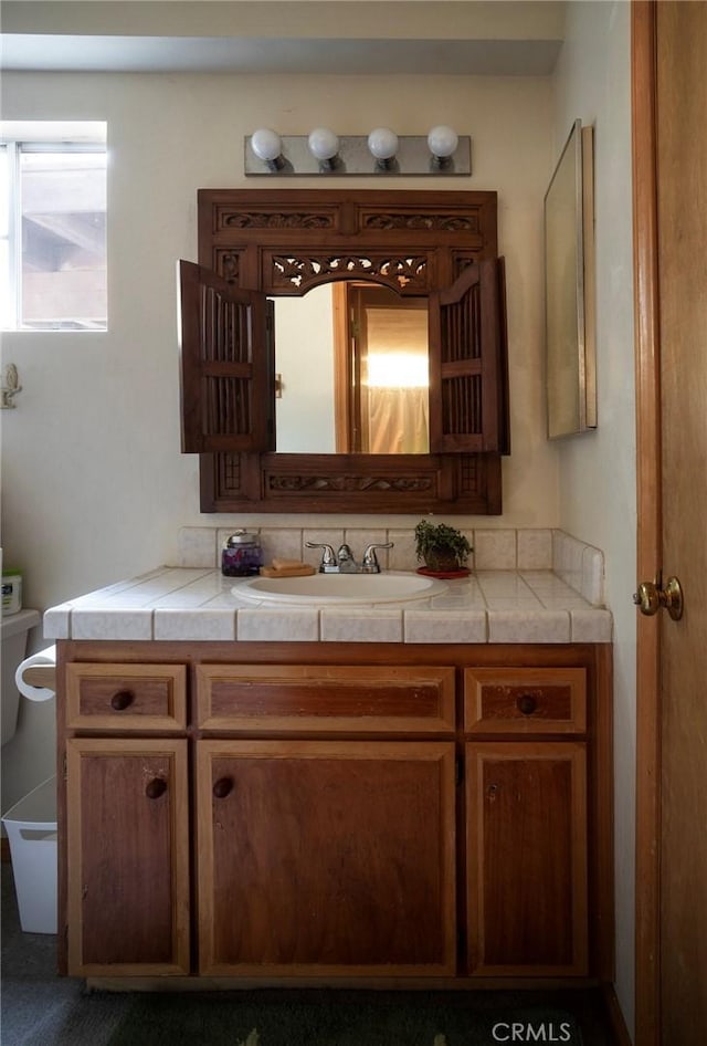 bathroom with toilet and vanity