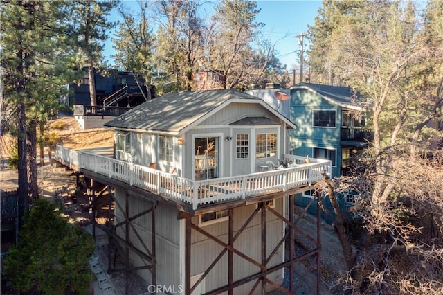 rear view of house featuring a wooden deck