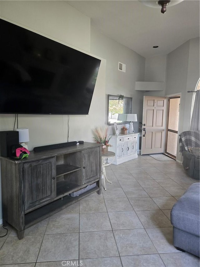 tiled living room with a towering ceiling