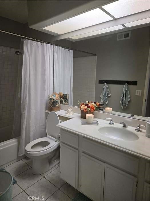 full bathroom featuring toilet, shower / tub combo, tile patterned floors, and vanity