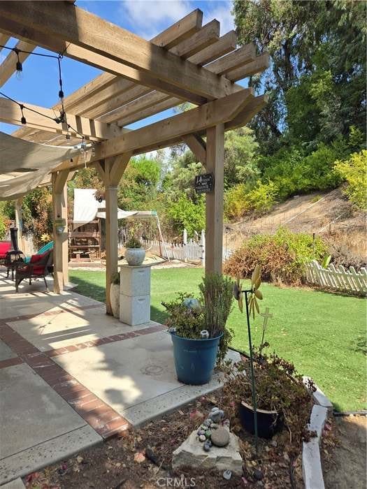 view of patio with a playground and a pergola