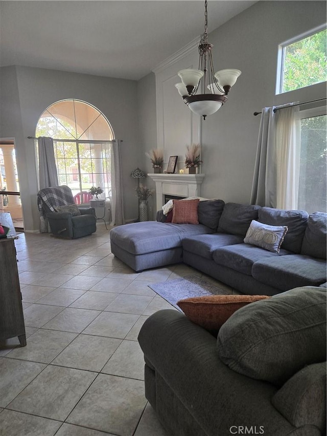 tiled living room with a chandelier