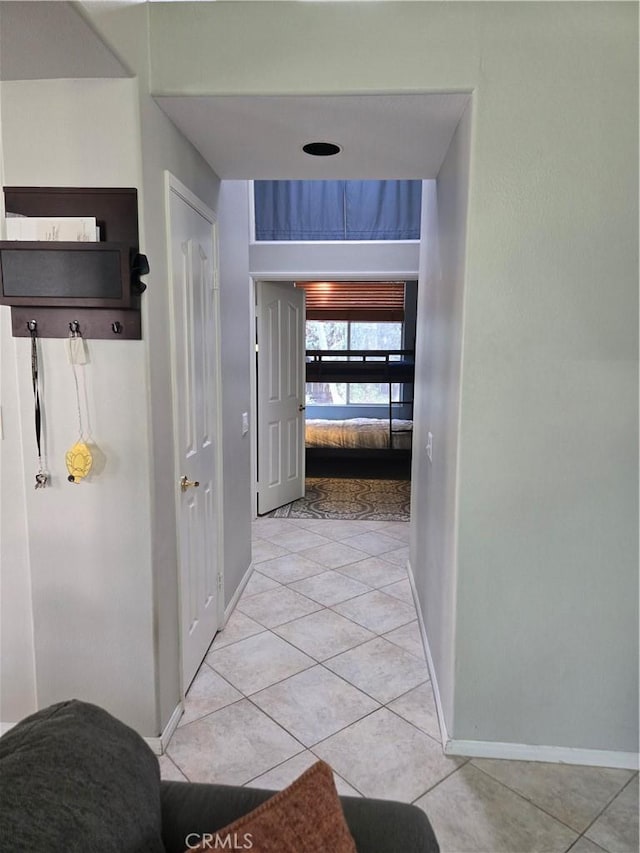 corridor featuring light tile patterned flooring