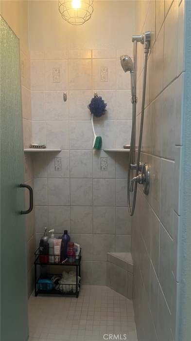 bathroom with a shower with shower door