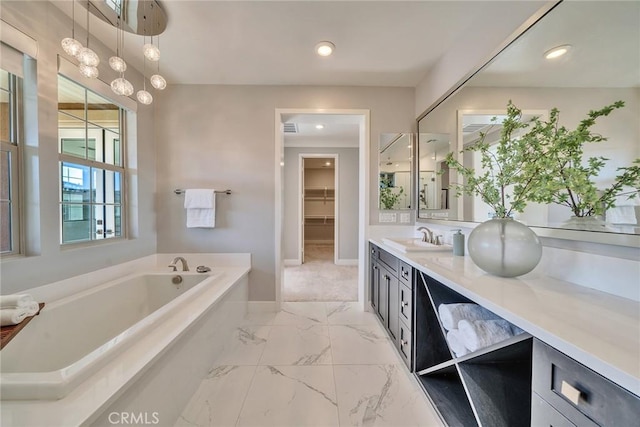 bathroom featuring a tub to relax in and vanity