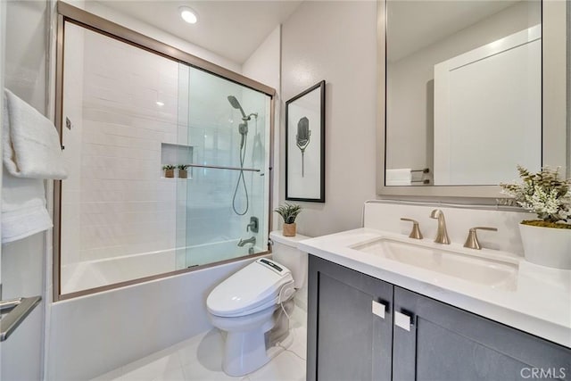 full bathroom featuring vanity, combined bath / shower with glass door, and toilet