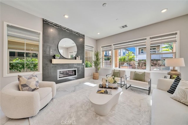 living room featuring a healthy amount of sunlight and a fireplace