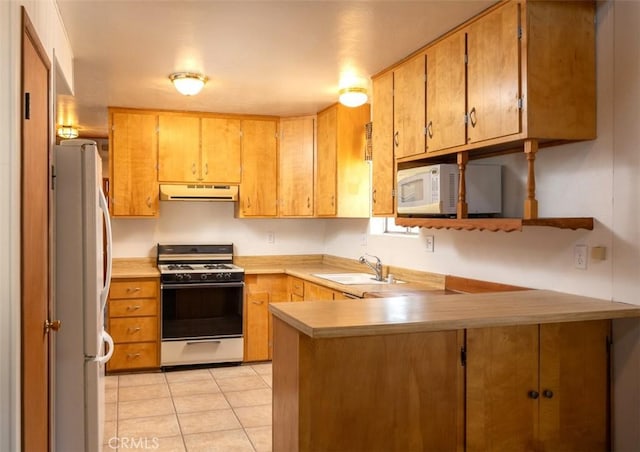 kitchen with light tile patterned floors, kitchen peninsula, sink, and white appliances