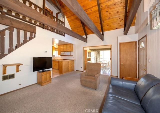 living room featuring wood ceiling, high vaulted ceiling, light carpet, and beamed ceiling