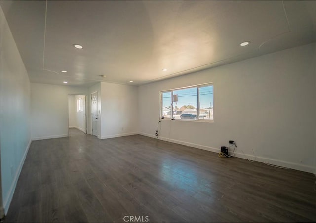 spare room featuring dark hardwood / wood-style flooring