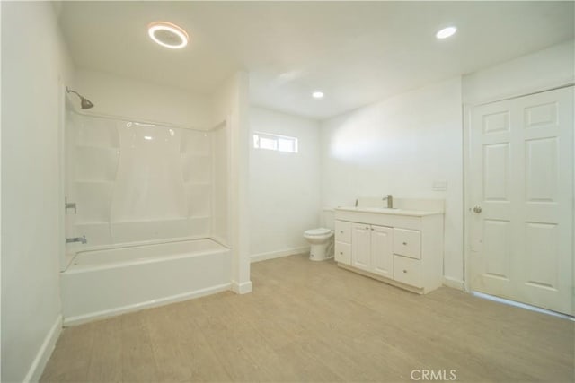 full bathroom with vanity, hardwood / wood-style flooring, bathtub / shower combination, and toilet