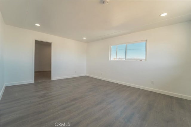 spare room featuring dark wood-type flooring