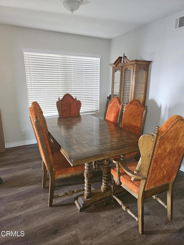 dining space with dark wood-type flooring