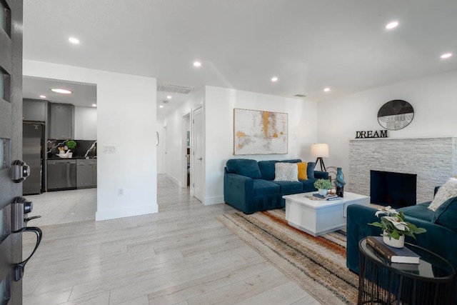 living room featuring light hardwood / wood-style floors and a fireplace