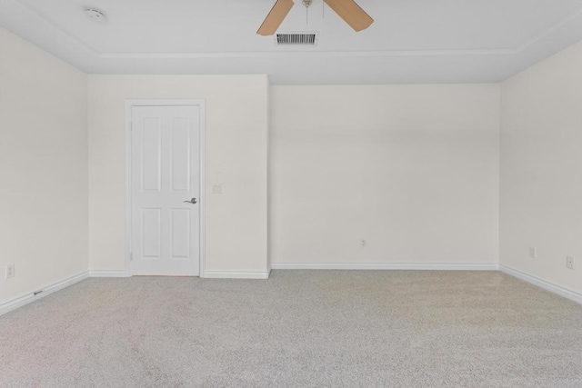 empty room featuring ceiling fan and light colored carpet