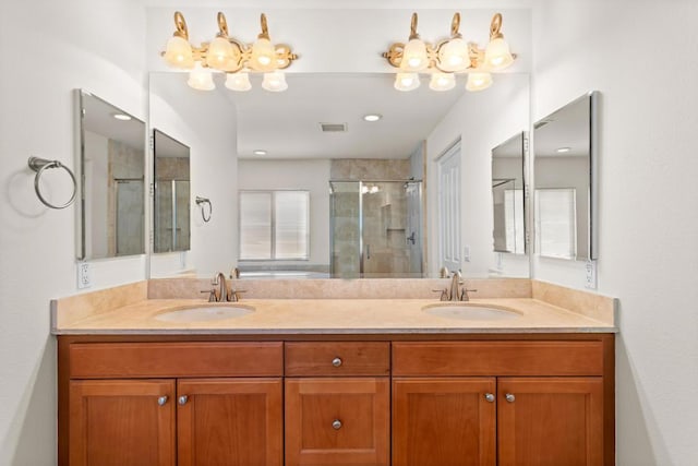 bathroom with an enclosed shower, a notable chandelier, and vanity