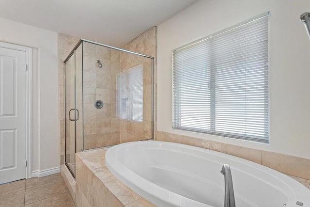 bathroom featuring tile patterned flooring and shower with separate bathtub