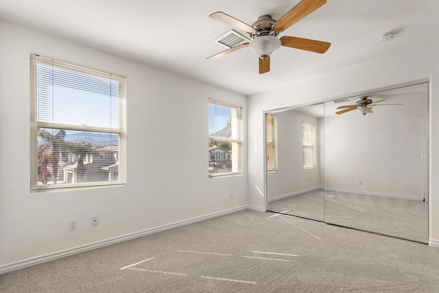 empty room with light carpet and ceiling fan