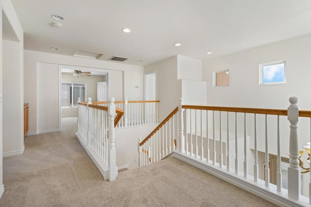 hallway featuring light carpet